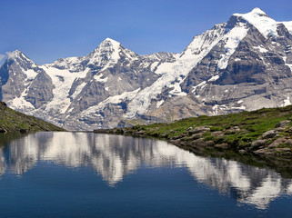 Eiger, Monch and Jungfrau mountains reflected in Grauseewli Lake, Switzerland Alps
