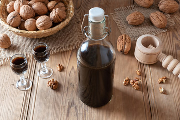 Fototapeta na wymiar A bottle of homemade nut liqueur with walnuts