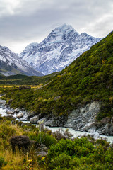 Obraz premium Scenic landscape view of Hooker Valley, Aoraki/Mount Cook National Park, South Island of New Zealand. Snow covered mountains. Tourist (backpackers) popular hiking or walking attraction/destination.