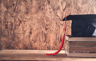 Graduation hat with books on table. Education concept