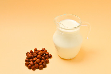 Hazelnut milk in a jar and nuts.
