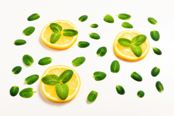 Mint leaves am lemon slices on white background
