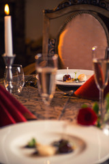 baked chicken wings with scallop and sauce served on white plate, romantic evening with delicios food on valentines day 