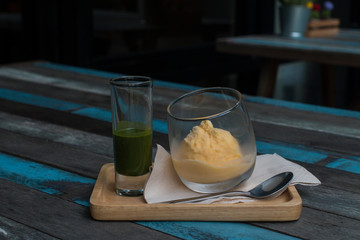 Delicious green tea Affogato serve on wood plate.