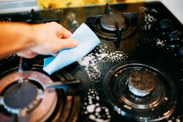 cleaning the kitchen, dirty gas stove with glass coating