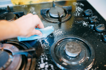 cleaning the kitchen, dirty gas stove with glass coating