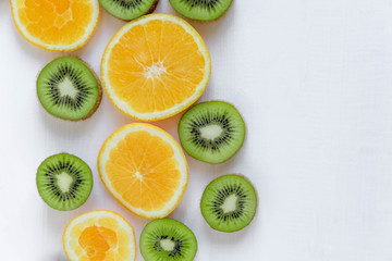 Fresh kiwi and orange sliced. Background for the profile, design, printing with fruit. The basis...