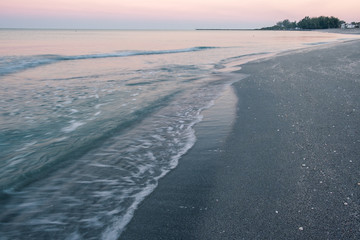 Beach waves washing ashore at sunrise