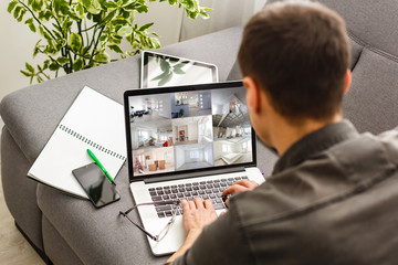 Happy young man with boxes moves to new apartment