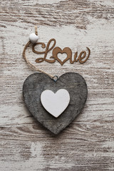 Wooden heart on a wooden background. Congratulations on the holiday. With love.