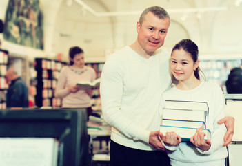 Girl with father holding books