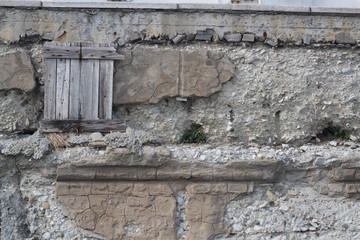 Old wall of the fortress with a wooden window.