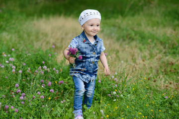 Cute baby girl with spring flowers