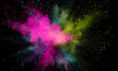 Explosion of colored powder on black background