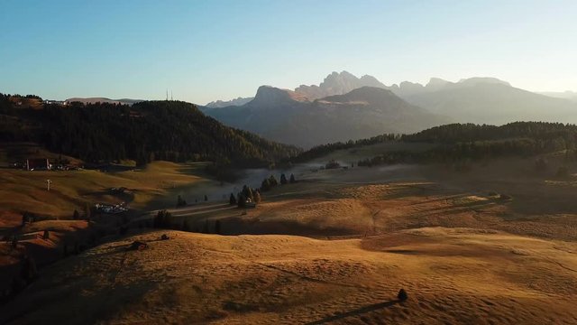 Aerial misty sunrise scenery at Alpe di Siusi, Dolomite Alps, Italy.