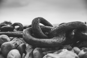 Rusty Chain on a Pebble Beach