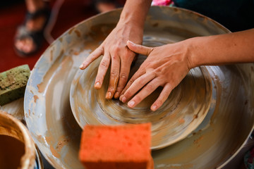 DIY crafts in the summer art camp. Ceramics. Hands on the potter's wheel