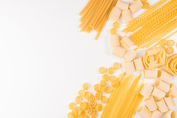 An overhead photo of different types of pasta, including spaghetti, penne, fusilli, and others,...