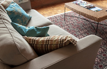 Corner of a comfy couch with pillows