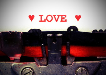 text by typewriter LOVE with red ink with vintage toned effect