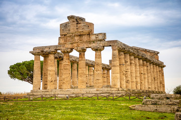 Fototapeta na wymiar Old ruins of Athena Temple in paestum, Italy