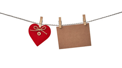 Red heart and blank card hanging on the clothesline isolated on white background