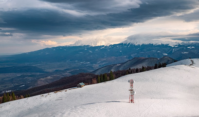 the telephone antenna on the mountain in the snow, Magura peak, Sibiu county, Romania