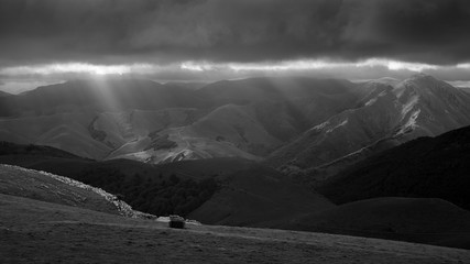 Sunbeams lance the stormy skies in the Pyrenees Mountains, Camino de Santiago