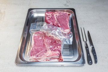 Elevatet view of beef in vacuum plastic bag for sous vide cooking
