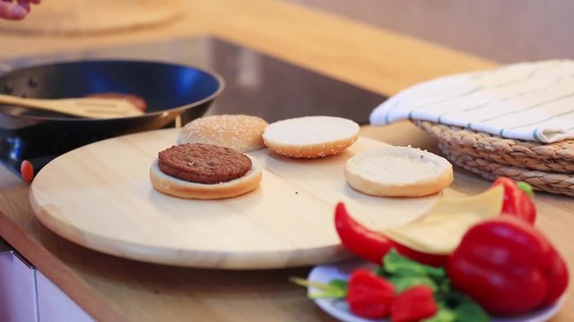 candind view at grilled mear and bun white cooking hamburger at home.