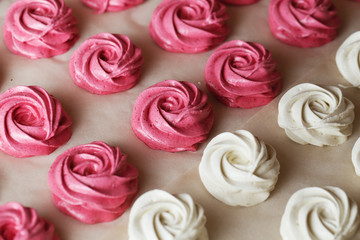 The process of making zephyr marshmallow at pastry shop kitchen. Fresh white and pink fruit marshmallow roses.