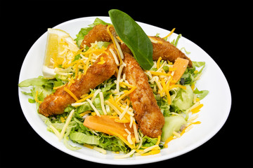 cesar salad in white plane on a black background