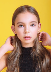 portrait of little model girl in studio