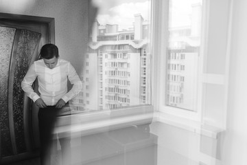 A man dresses his white shirt black and white.