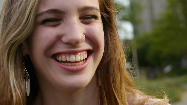 Closeup Of Pretty Teen Girl Laughing Really Hard In The Park At Sunset