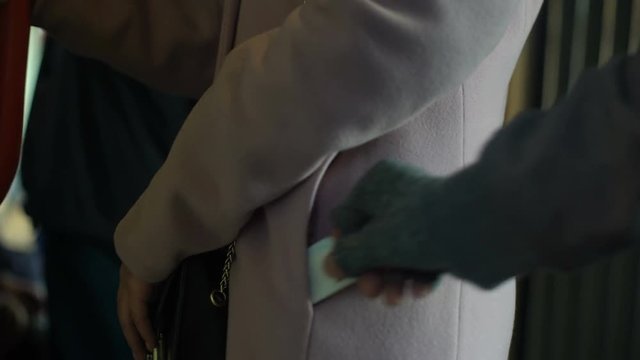 Criminal stealing money from careless female commuter pocket, pickpocketing