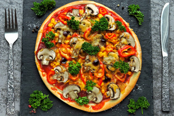 Vegan pizza with vegetables and mushrooms. The concept of healthy food without meat.