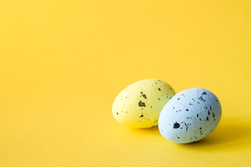 Bright Easter decorative eggs on a yellow background, close up, soft focus. Easter background