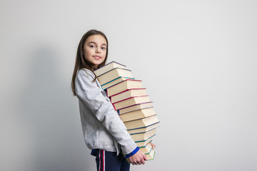 background. beautiful strong girl holding books.