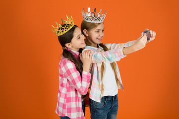 Demand more attention. Kids wear golden crowns symbol princess. Warning signs of spoiled child. Avoid raising spoiled kids. Girls taking selfie photo smartphone camera. Spoiled children concept