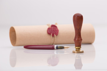 Fountain pen and old notarial wax seal on document