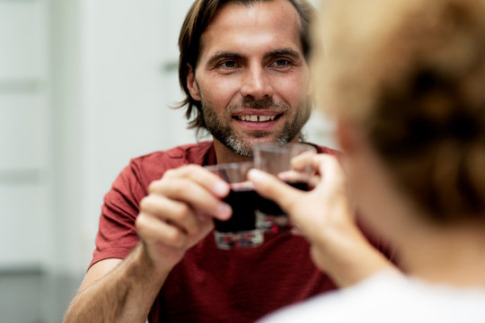 Happy couple toasting with red wine