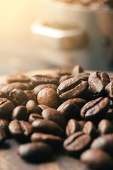 Black fried coffee beans on dark textured background