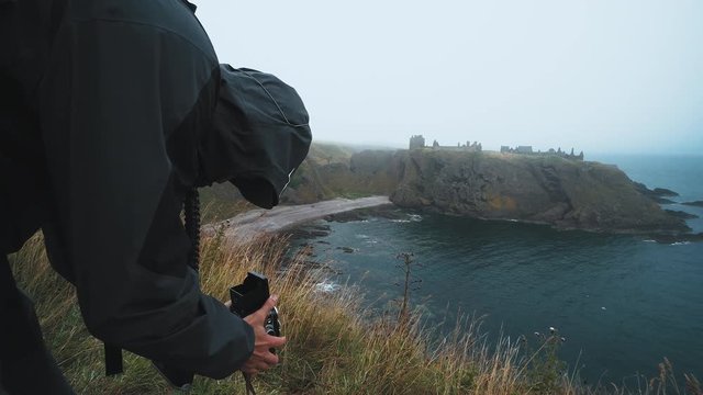 A man taking photographs with an old fashioned twin lens reflex film camera
