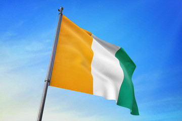 Cote d'Ivoire flag waving on the blue sky 3D illustration