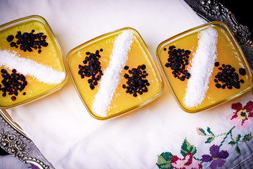 yellow pudding with coconut decoration