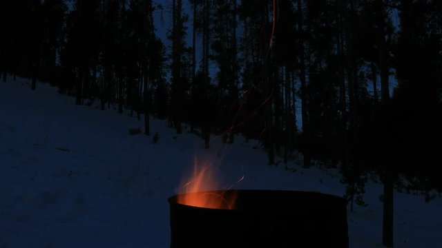 Burn barrel flames in winter landscape - 4k time lapse