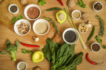 Variety of herbs, spices, fruits and vegetables on the wooden table
