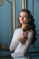 Portrait of young gorgeous bride in her stylish wedding dress