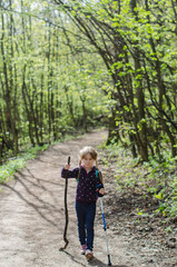 Girl walk or hike through the forest in early spring